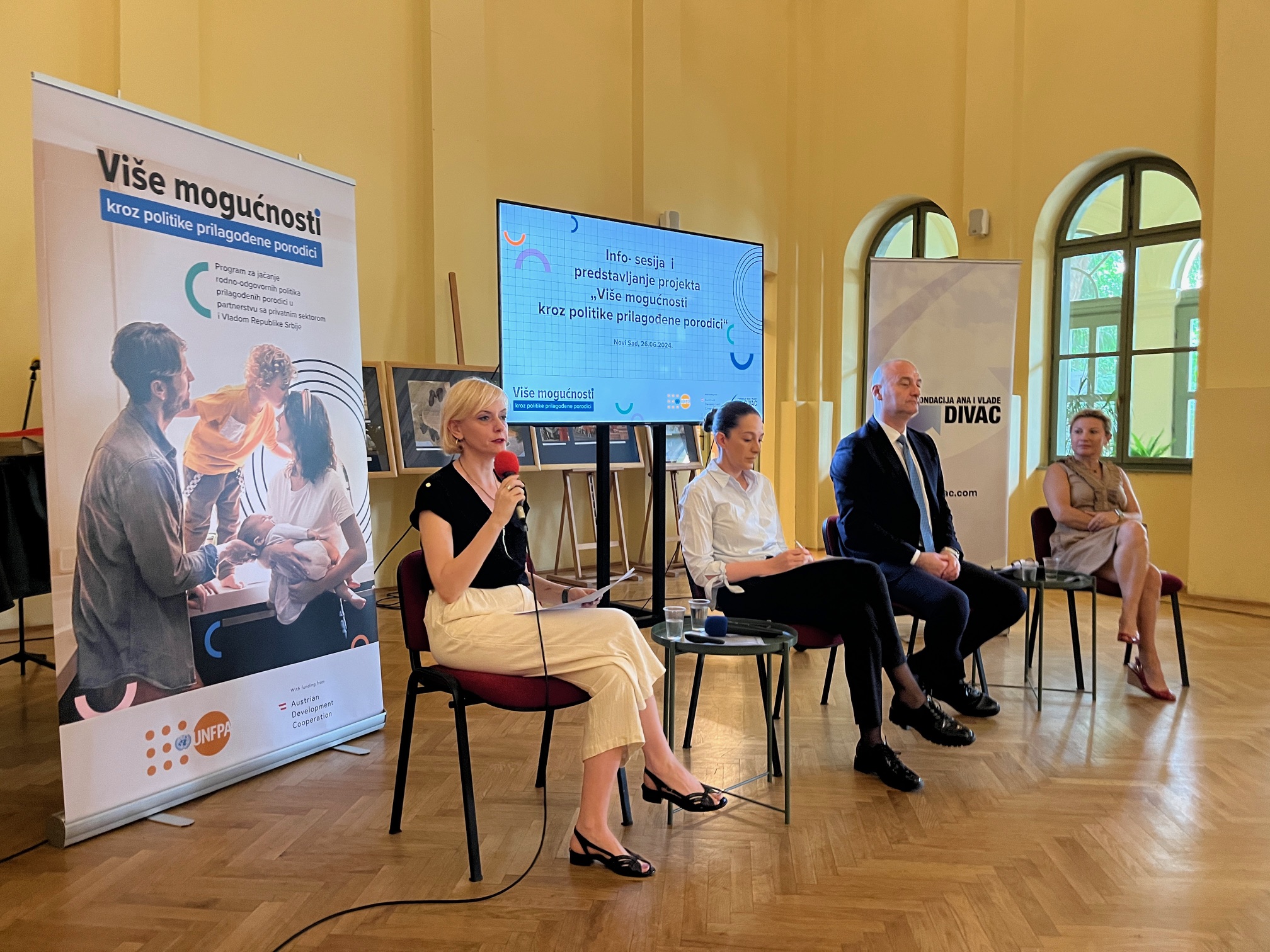 Four panelists , addressing an audience .The backdrop includes promotional UNFPA and Divac Foundation banners and a large screen